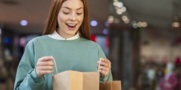 happy woman looking shopping bag scaled 1