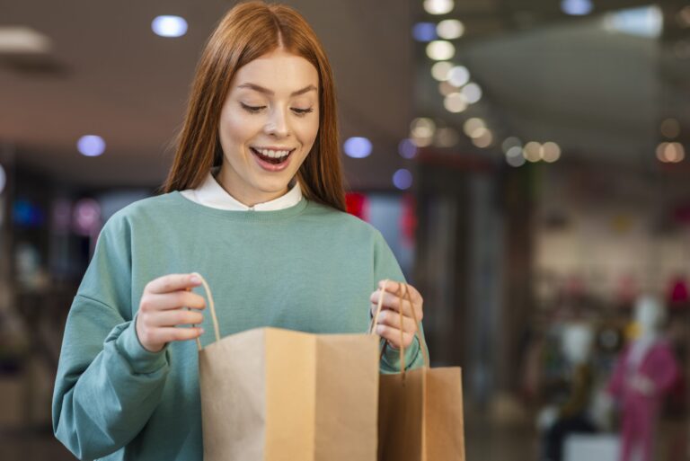 happy woman looking shopping bag scaled 1