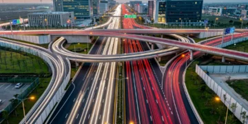 Highway interchange with modern infrastructure and car lights, representing federal transportation grants