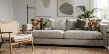 Modern living room with bouclé sofa, botanical print pillows, and natural fiber rug, reflecting 2026 textile trends.