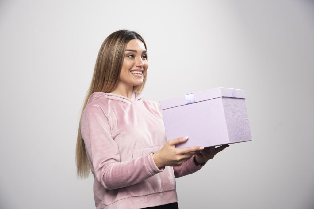 blonde girl sweatshirt received gift box feels positively surprized